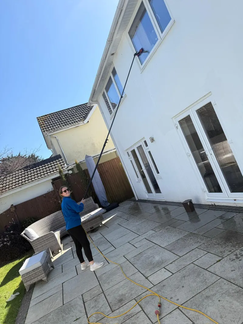 A member of our family-run team cleaning windows at a Dorset home